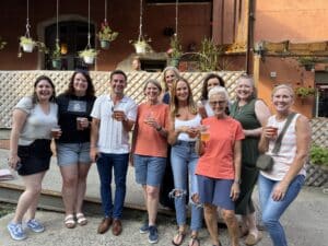 Group of about ten smiling PSPCA supporters holding drinks at an outdoor patio gathering — team or fundraiser event
